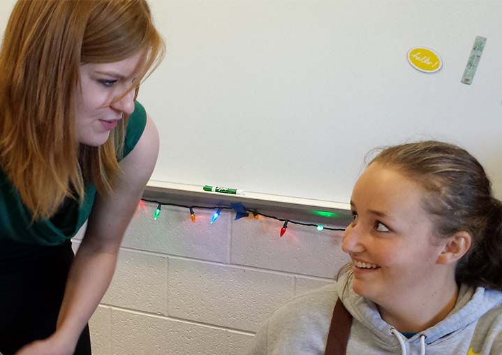 Mary Beth Hills talks to student Kylie Piatt about French