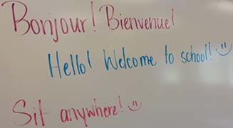 Messages in French and English greet students in Mary Beth Hills' French 1 class