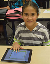 Sixth grade student Aleena Carter uses the touch screen