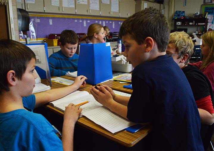 Nicholas Wentworth, left, discusses how to start his essay with Kaleb Harper