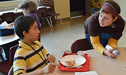 Seventh-grade student Anthony Sanchez chats with KSSN leader Alison Corso