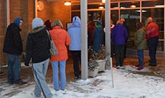 Parents line up at Zinser Elementary School, waiting for the bell before going inside and picking up their children