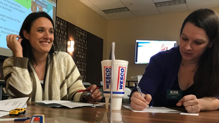 KDL youth librarians Sara Magnuson, left, Ashley Smolinski discuss strategies to help elementary students meet the new third-grade reading law