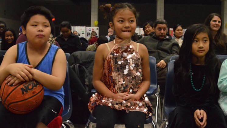 From left, students Son Trieu, Aster Siang and Ruth Sang wait for their names to be announced following their presentations