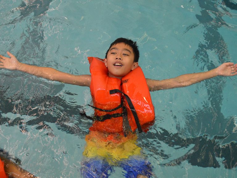 Fifth-grader Jaden Nguyen floats on his back, a water safety skill