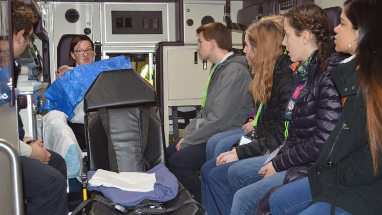 Life EMS paramedic Jen Barnes explains equipment that is standard in every ambulance to (seated on right side, from left) Jaren Rhein of Forest Hills Eastern High School; Brooklyn Dornbos; of Calvin Christian (partially hidden); Marijane Morse of Forest Hills Northern; Claire Benedict of Forest Hills Eastern; and Yamilet Reyes of Wyoming High School