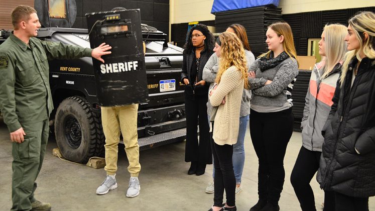 About a dozen students spent Groundhog Shadow Day at the Kent County Sheriff’s Department; here, tactical team member Sgt. Justin Deboode shows some of his equipment