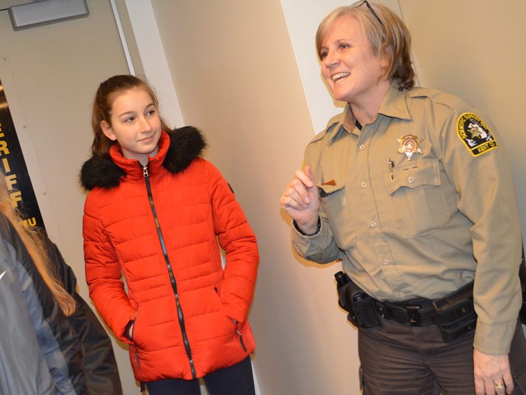 Kent County Sheriff’s Department forensic technician Dawn TenBrink shows students from Forest Hills, Lowell, East Kentwood and Wyoming around a simulated crime scene