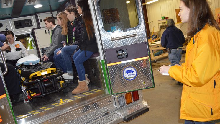 Allison Gates takes notes outside a Life EMS ambulance during Groundhog Shadow Day; Alison was shadowing School News Network reporter Morgan Jarema to find out about careers in writing