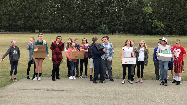 Social studies teacher Kyle Carhart’s students carried boxes filled with textbooks this fall to simulate what it’s like for their Sudanese counterparts to carry water every day