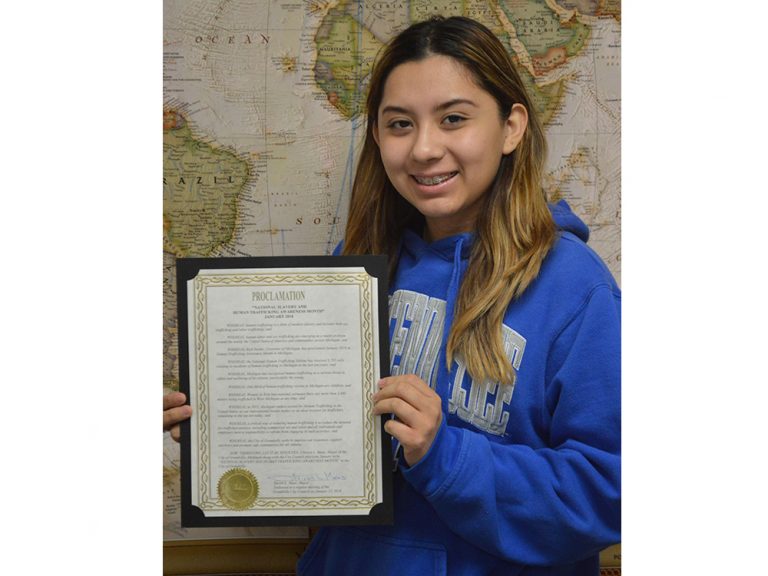 East Lee senior Mitzi Hernandez holds a proclamation by the Grandville City Council declaring January “National Slavery and Human Trafficking Awareness Month”