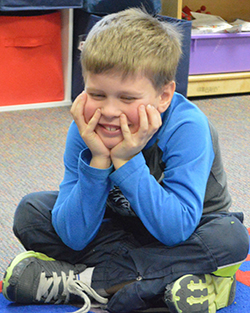 Emmons Lake kindergarten student Drake VanLente demonstrates “not following the group plan” by staying seated while his classmates return to their desks