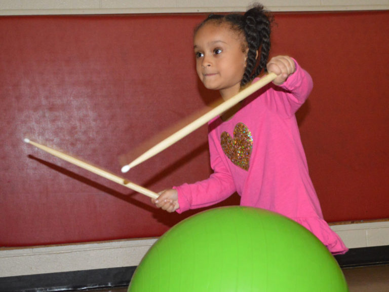 Students work out by whacking away with drumsticks