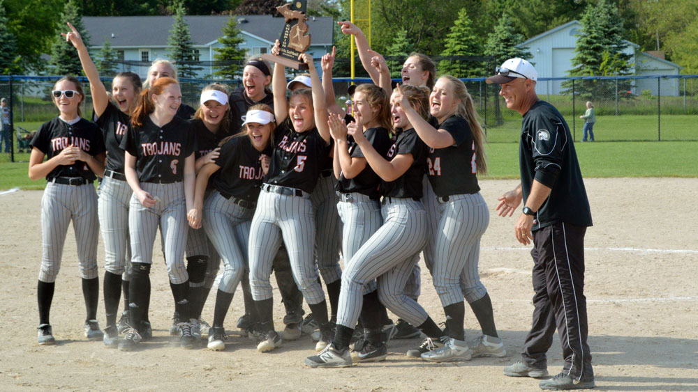  Thornapple Kellogg softball team celebrates its Division 2 district championship win over Wayland on June 3 in Hopkins