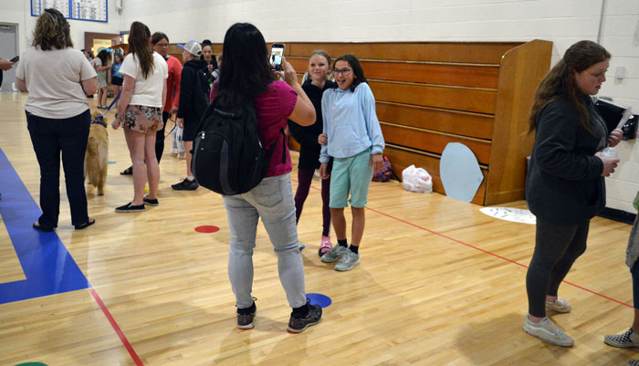 Students Maya Smitter, left, and Brianna Lixey ham it up for snapshot memories of a special day 