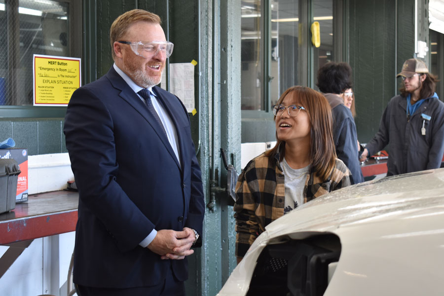 Kent ISD Assistant Superintendent Ron Gorman talks with Kent Career Tech Center automotive student Dawt Len Par, an East Kentwood senior