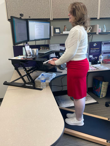 Camela Diaz gets her steps in, while collaborating with principals, on her office treadmill 