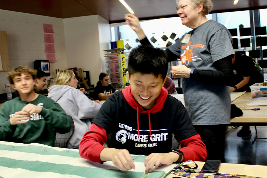 Evan Liu, a Thornapple Kellogg High School sophomore, chooses to spend part of his service morning making sleeping bags for unhoused people in Michigan