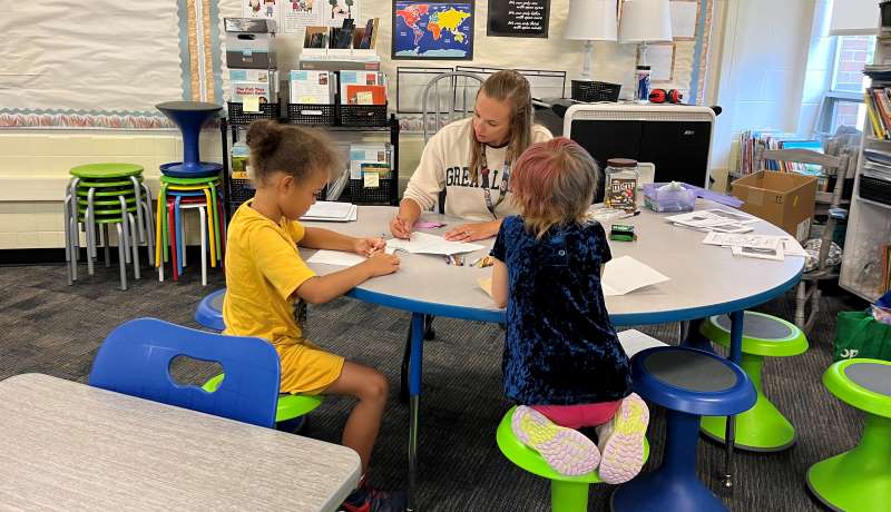 First-grade teacher Alexa Andresen works with students Neko Johnson, left, and Ezer Segner