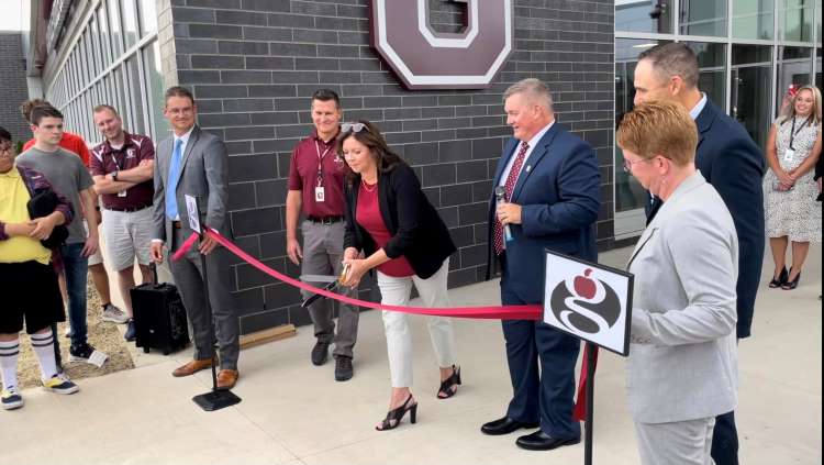 Grandville Public Schools Board of Education President Kim Klein cuts the ribbon, officially opening the new Grandville Middle School