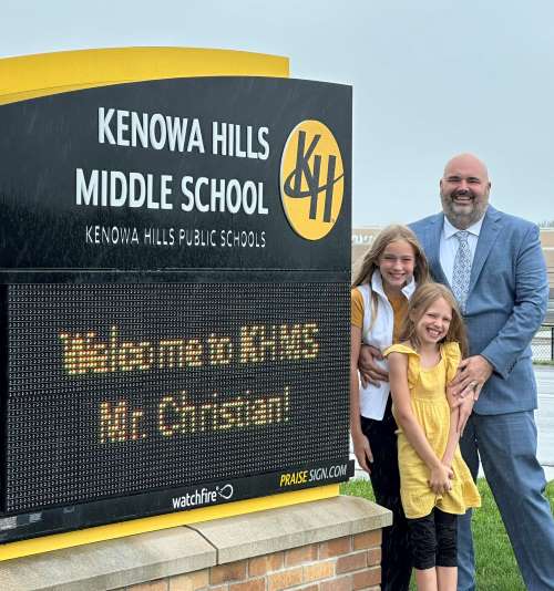 Kenowa Hills Middle School’s new principal, Zach Christian, and his two daughters Izzy, left, and Zoe