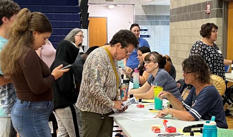 Kelloggsville parent Robin Marihugh reviews registration forms
