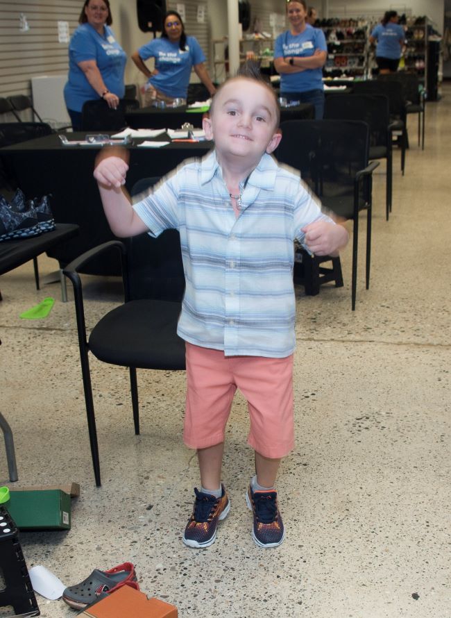 Grandville East Elementary first-grader Louie Sheick wiggles around with his new shoes 