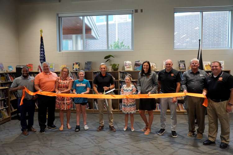 Nickels Intermediate Principal Tom Trout cuts the ribbon to officially open the new fifth- and sixth-grade building