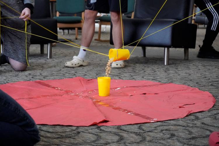 When successful, the string-and-rubber band systems  transferred the ‘toxic’ corn kernels without the students touching the cups 