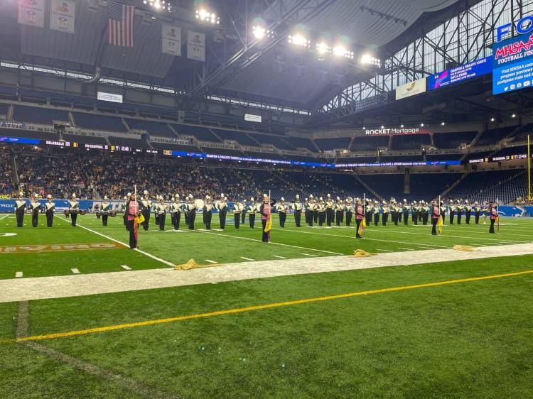 Forest Hills Central’s marching band performs at Detroit’s Ford Field during the 2022 Michigan High School Athletic Association’s state football finals 
