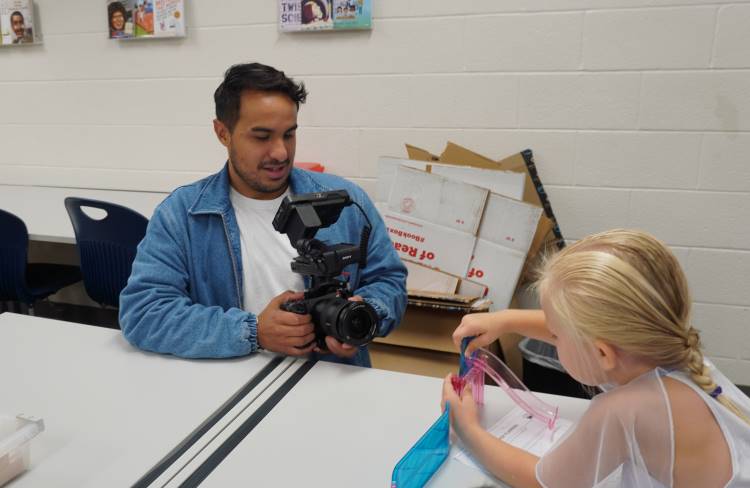 Videographer Omar Arredondo films a Young Fives student creating her maze