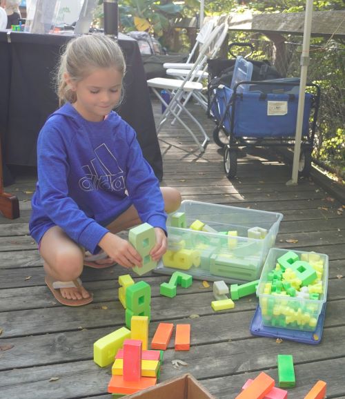 Adams Christian second-grader Milly Spriensna builds a tower using number blocks