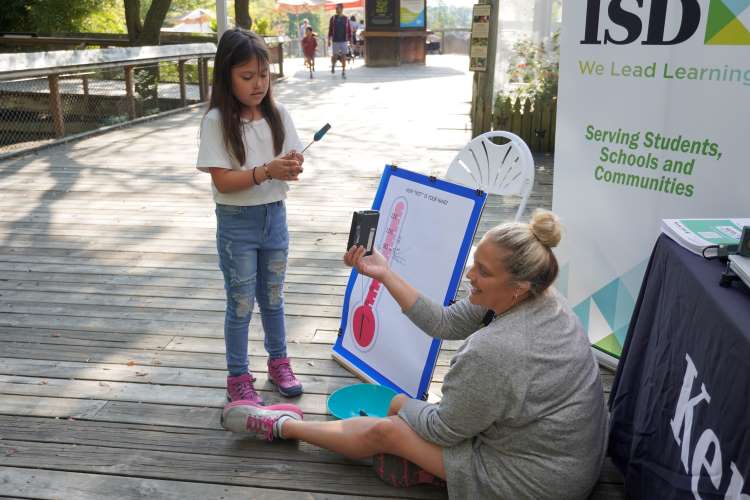   Zeeland Christian third-grader Coralynn Pierce does a temperature experiment with Kent ISD Educational Consultant Wendi Vogel

