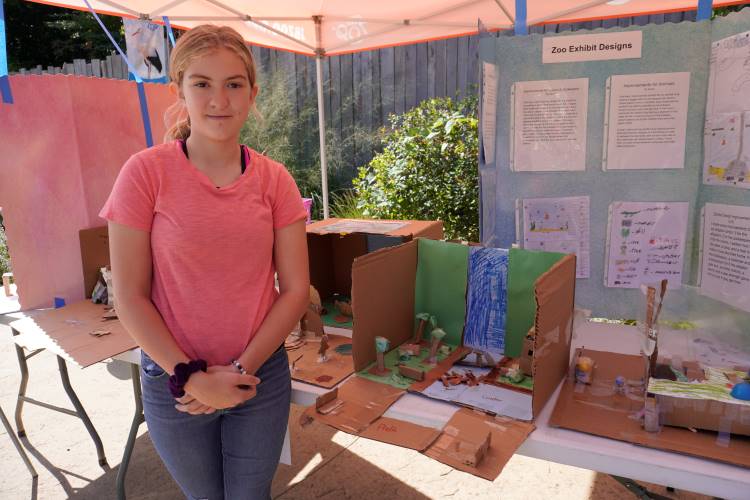 Grand Rapids Montessori Academy sixth-grader Lexi Trudeau next to the beaver habitat she created