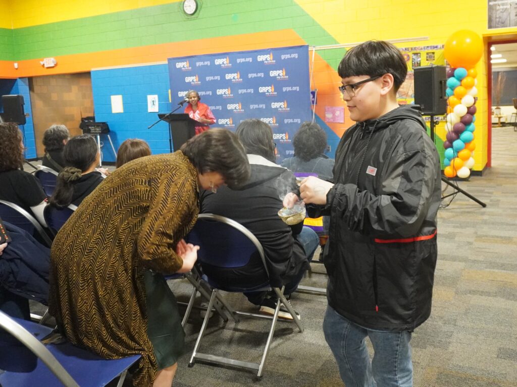 A student leads a smudging ceremony.