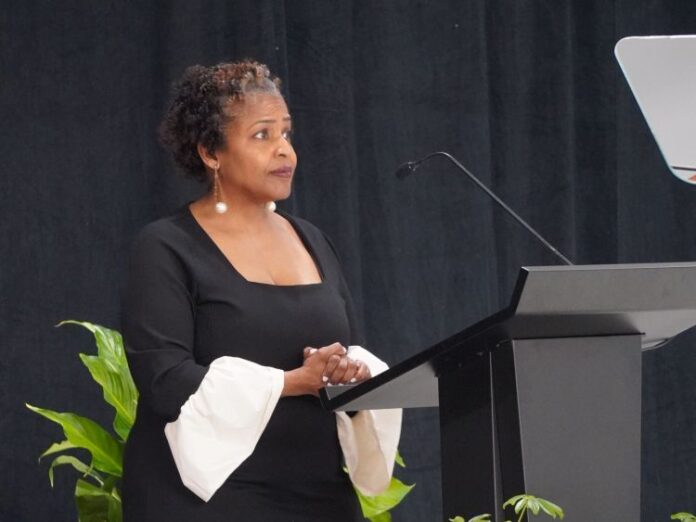 Superintendent Leadriane Roby stands behind a podium.